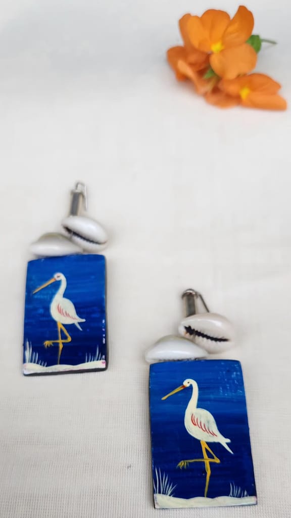 Hand painted wooden earrings featuring a blue heron design, made with sustainable materials.