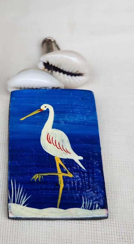 Hand painted wooden earrings featuring a blue heron design, made with sustainable materials.