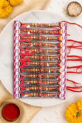 Celebrate Raksha Bandhan with this elegant set of 12 lotus design rakhis. Featuring pearl-like beads, yellow accents, and red-yellow threads for a festive traditional look.