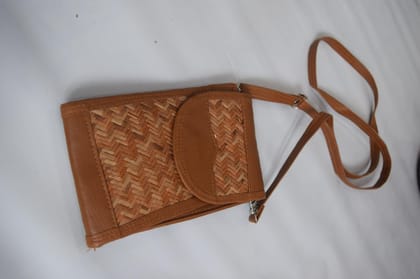 TULIP Traditional Artisians' Upliftment Livelihood Program Handwoven Rattan Crossbody Bag, Brown Leather Trim, Woven Straw Pattern, Metal Buckle Closure TULIP Traditional Artisians' Upliftment Livelihood Program Handwoven Rattan Crossbody Bag, Brown Leather Trim, Woven Straw Pattern, Metal Buckle Closure