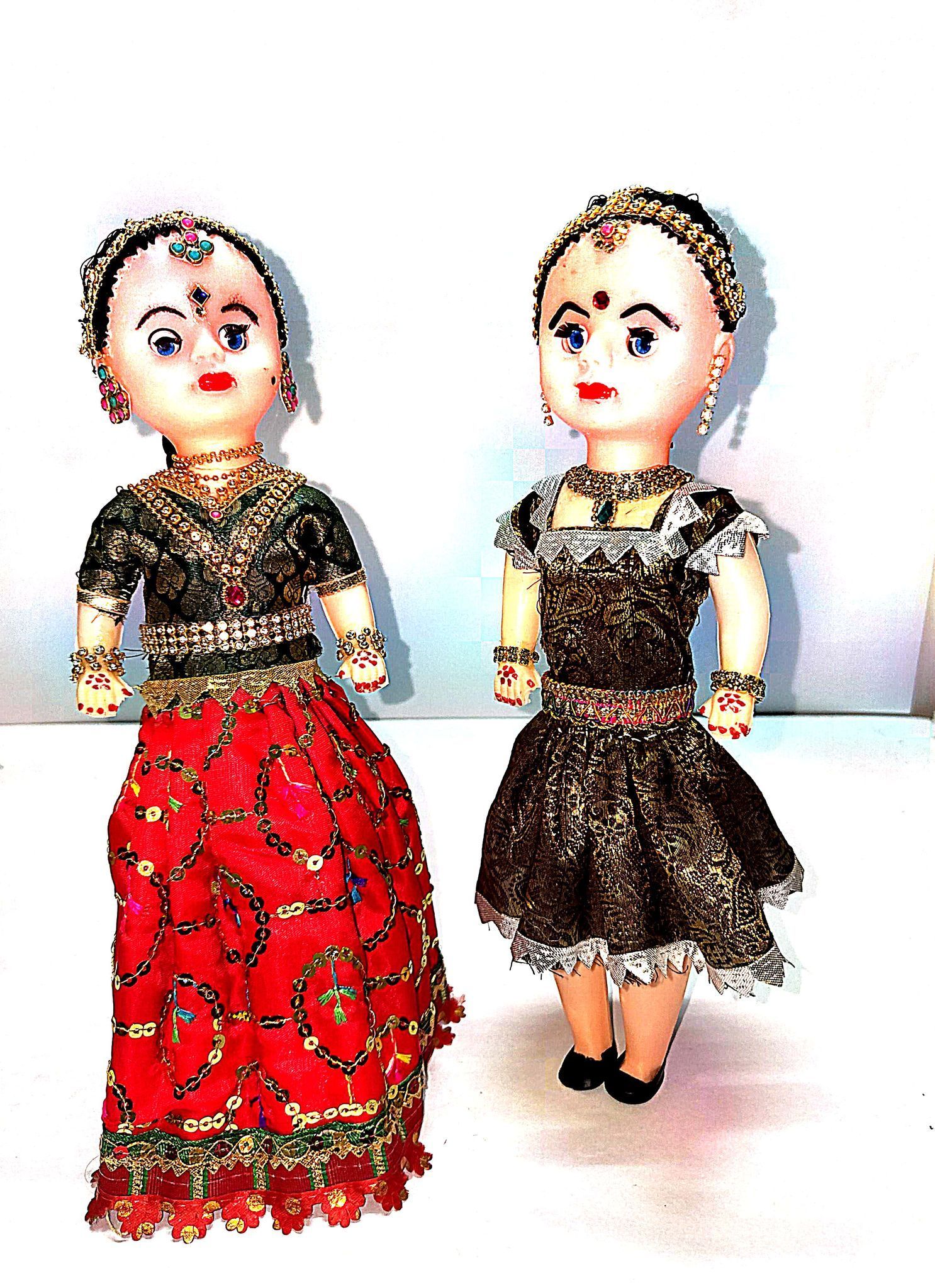 Indian Traditional Dolls in Colorful Attires**Meta Description:** These Indian traditional dolls are dressed in colorful and intricate outfits, making them perfect for display or as a gift.
