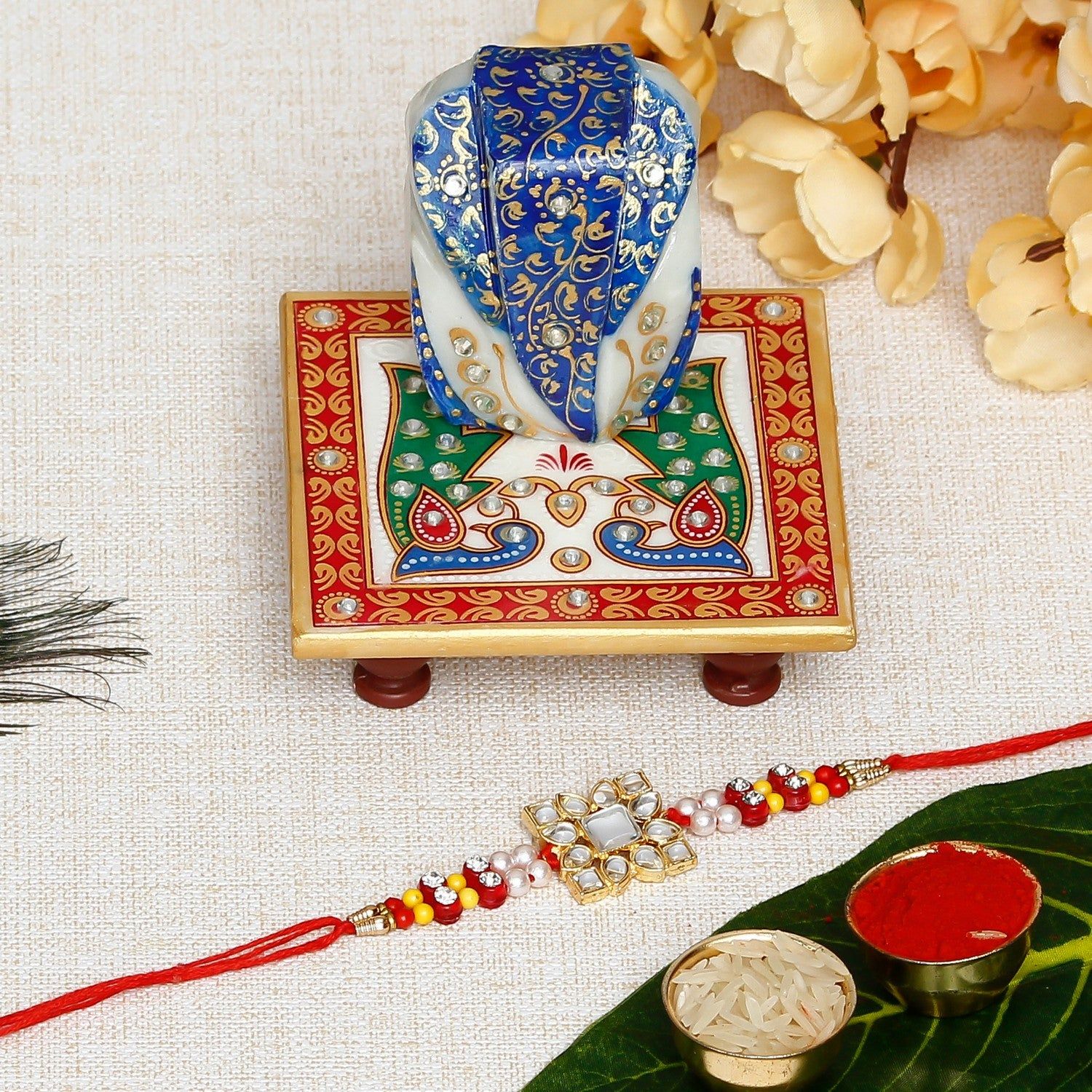 Designer Stone Work Rakhi with Lord Ganesha on Marble Chowki and Roli Chawal Pack