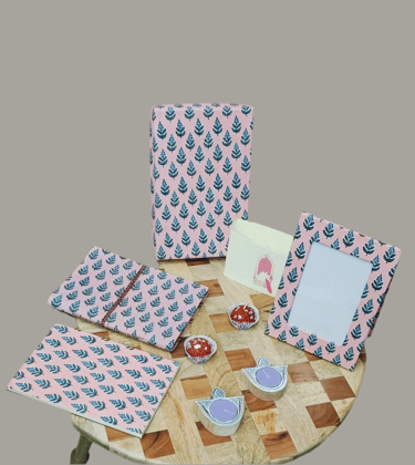Gift Box with Work Desk Essential : 1 Diary, 1 Notepad, 1 Photoframe, 2 laddoo candles, 2 handblock candles-1 Diary, 1 Notepad, 1 Frame, 4 Candles