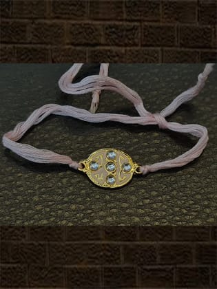 Oval pink enamel kundan stone rakhi with light pink thread
