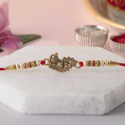 eCraftIndia Golden & Red Beautiful Peacock Designer Rakhi with Roli Chawal Pack