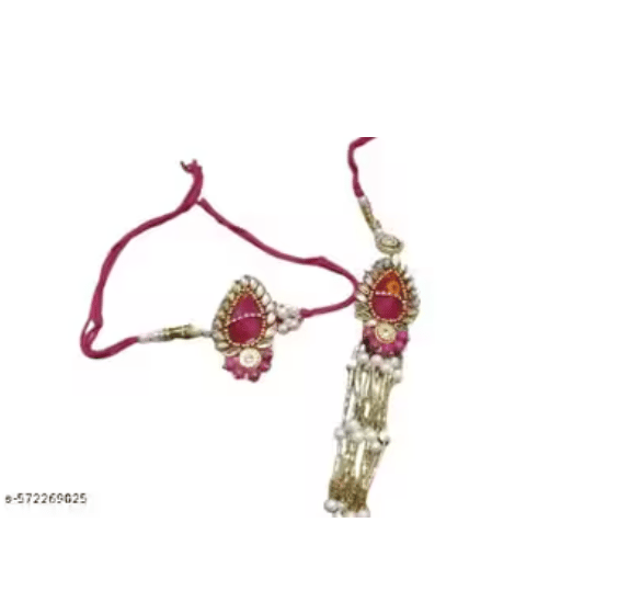 The bhabhi rakhi (lumba) is enhanced with multi-strand pearl tassels, adding a regal flair. Tied with elegant magenta threads, this set symbolizes grace, tradition, and the timeless bond of love.