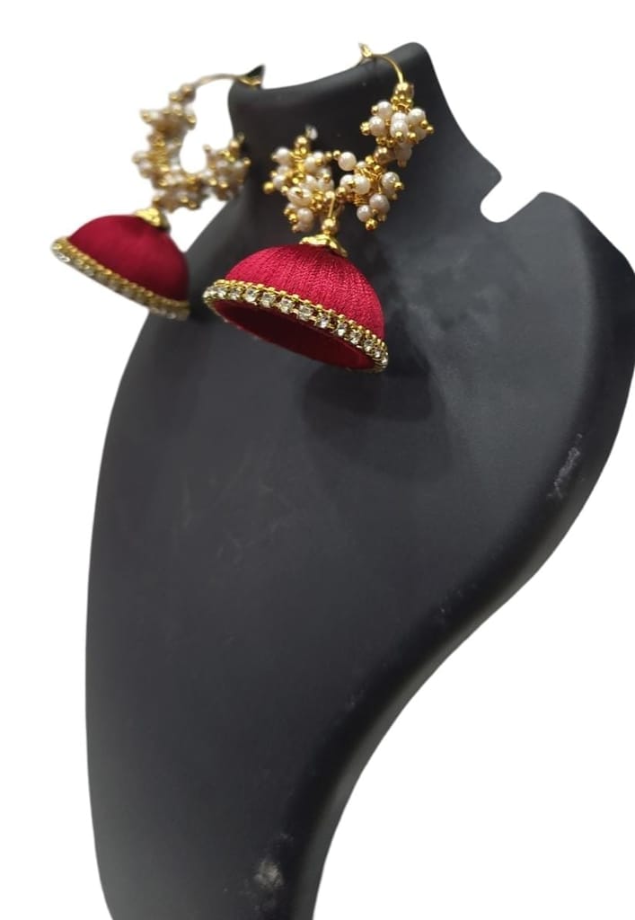 Red and gold jhumka earrings with pearl and kundan accents
