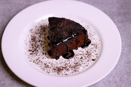 Death by choco cake slice with chocolate sauce