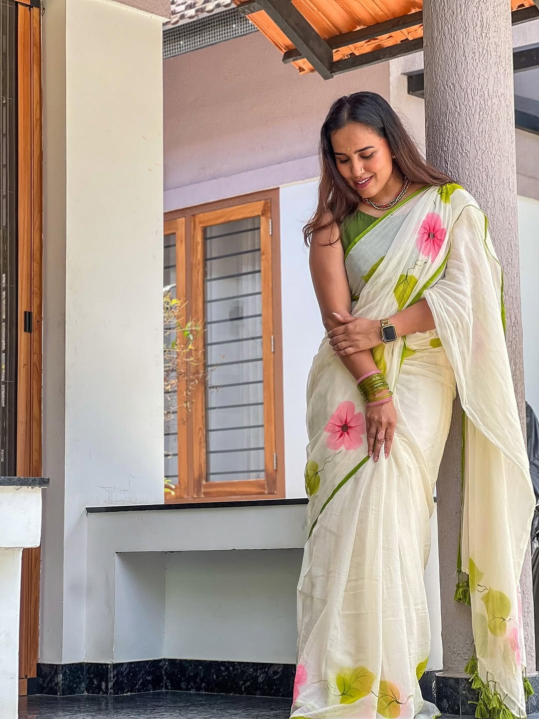 Nature Inspired: White Linen Saree with Hand-Painted Style Pink Flowers & Green Blouse