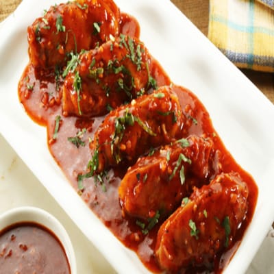 Chicken Darjeeling Pan Fried Momo In Schezwan Sauce (Spicy)