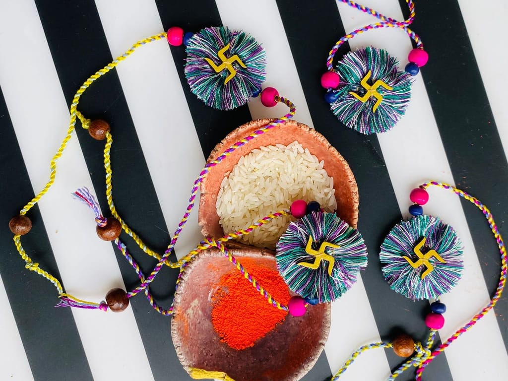 Aqua Fireworks Swastik Rakhi - 1 piece