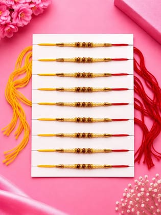 Celebrate Raksha Bandhan with this elegant set of 12 lotus design rakhis. Featuring pearl-like beads, yellow accents, and red-yellow threads for a festive traditional look.