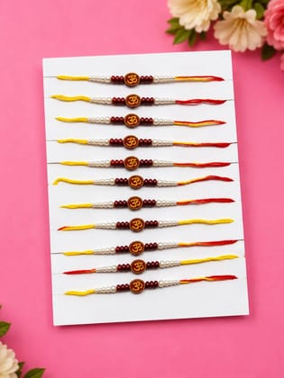 Celebrate Raksha Bandhan with this elegant set of 12 lotus design rakhis. Featuring pearl-like beads, yellow accents, and red-yellow threads for a festive traditional look.