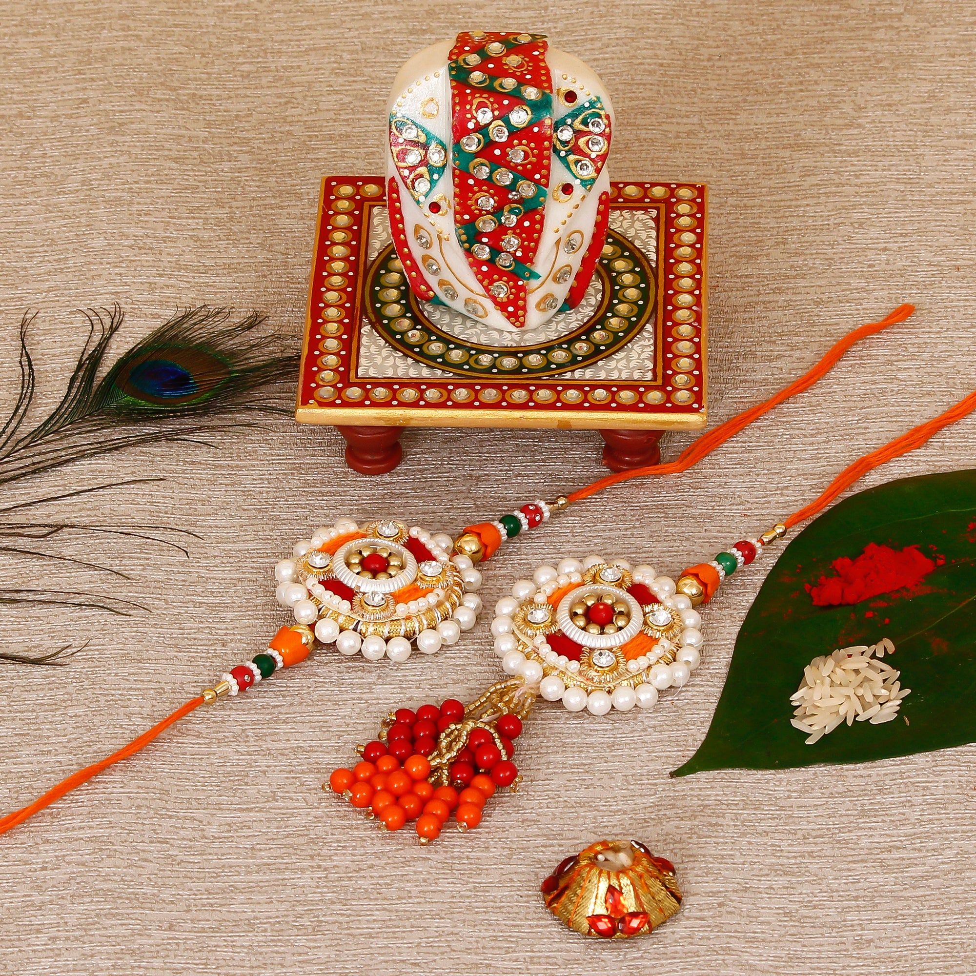 Designer Bhaiya Bhabhi Rakhi with Lord Ganesha on Kundan Studded Marble Chowki and Roli Tikka Matki