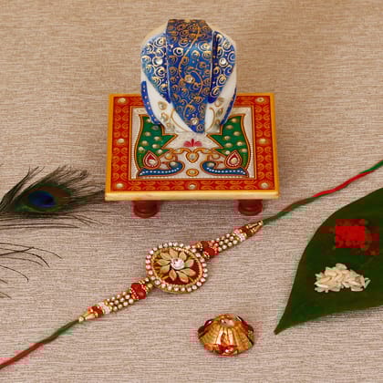 Designer Rakhi with Lord Ganesha on Marble Chowki and Roli Tikka Matki