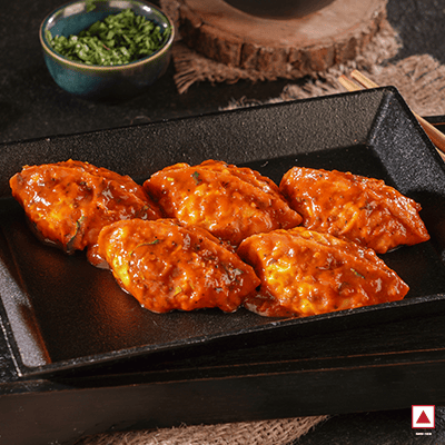 Chicken Masala Pan Fried Momo In Tomato Garlic Sauce