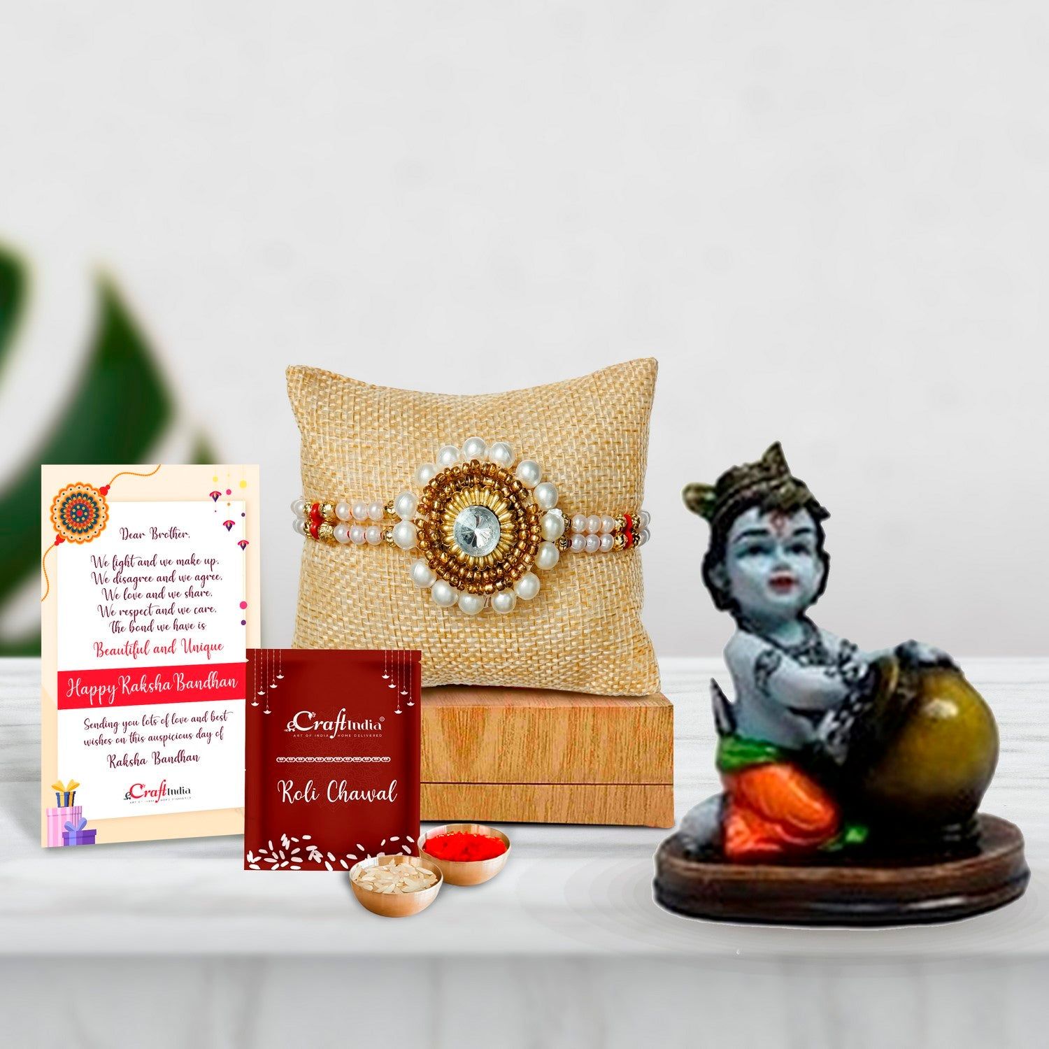 Designer Handcrafted Stone Pearl Rakhi with Decorative Showpiece of Makhan Chor and Roli Chawal Pack, Best Wishes Greeting Card