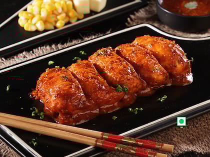 Corn Cheese Pan Fried Momo In Schezwan Sauce (Spicy)