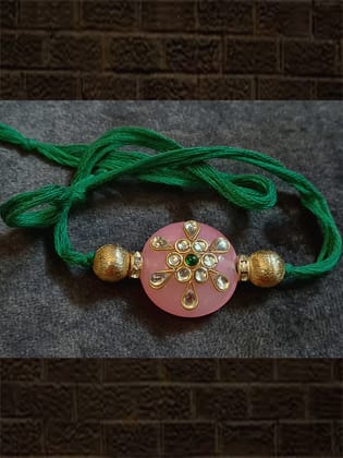 Pink round bead kundan work with side gold beads rakhi