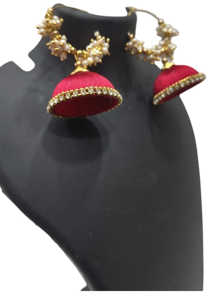 Red and gold jhumka earrings with pearl and kundan accents