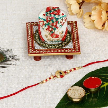Designer Peacock Rakhi with Lord Ganesha on Kundan Studded Marble Chowki and Roli Chawal Pack