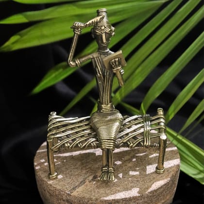 Dhokra Craft Depicting a Tribal Woman Seated on a Bed with Mirror and Comb