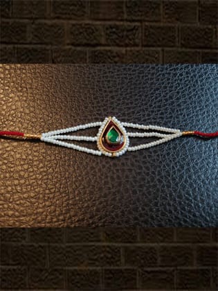 Leaf design enamel work green stone rakhi with pirohi and three cheed string dori-Red enamel green stone