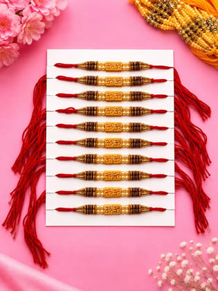 Celebrate Raksha Bandhan with this elegant set of 12 lotus design rakhis. Featuring pearl-like beads, yellow accents, and red-yellow threads for a festive traditional look.