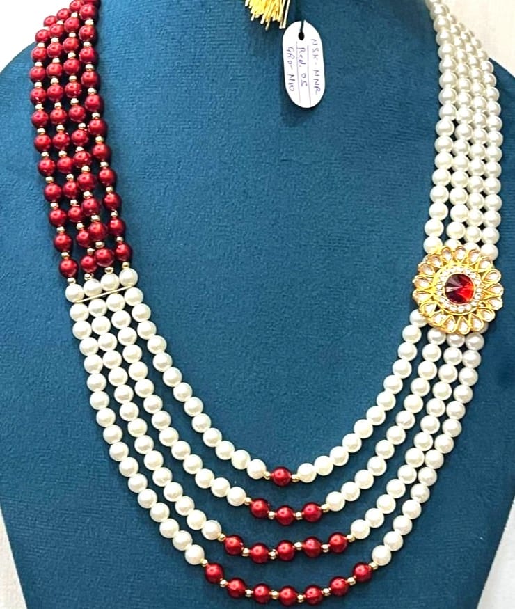 royal dulha haar with round kundan side brooch and maroon central gemstone